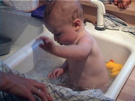 Baby Sam stirring up a storm in the Kitchen Sink